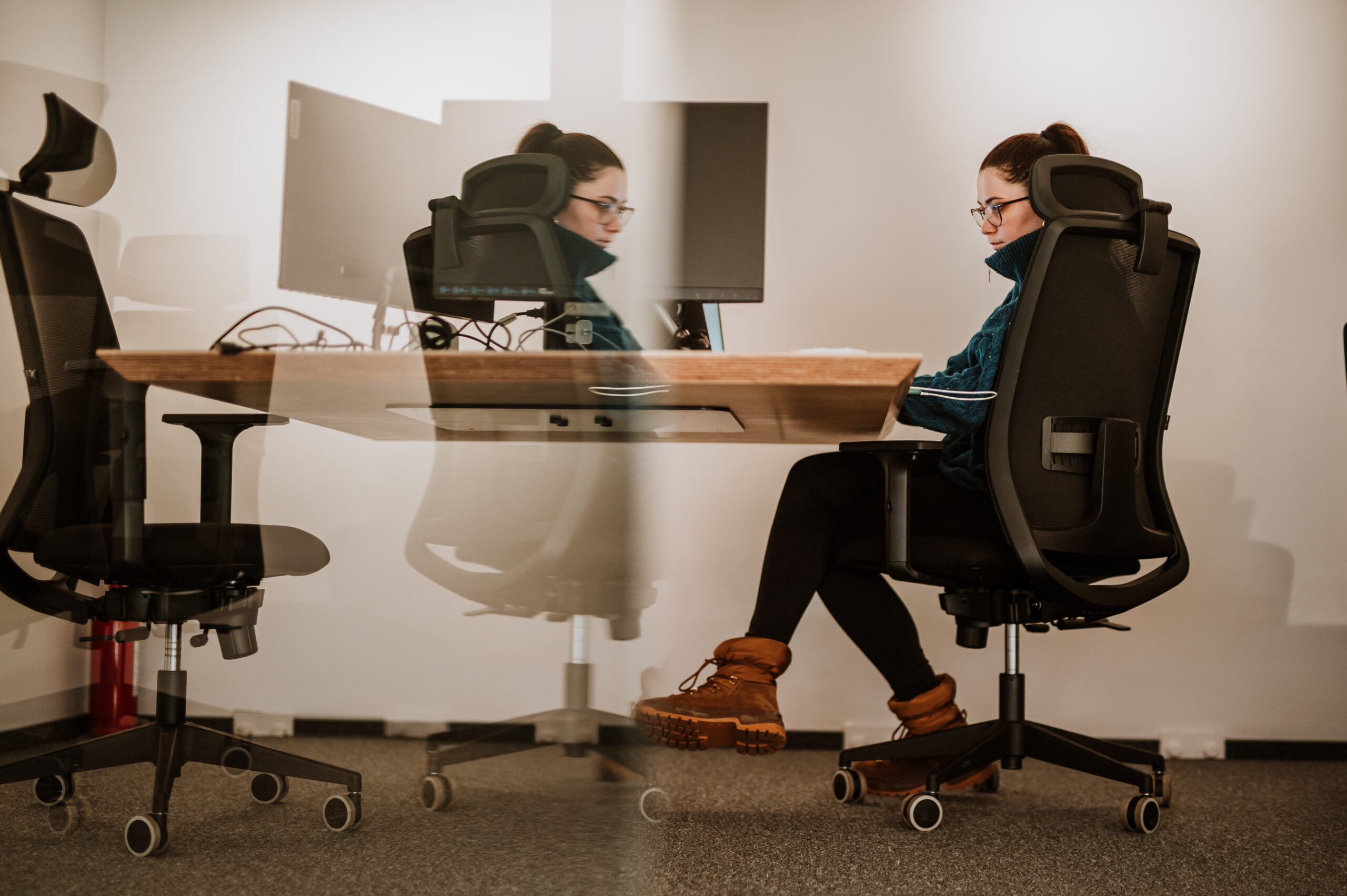 Two BetterQA engineers working side by side at their desks