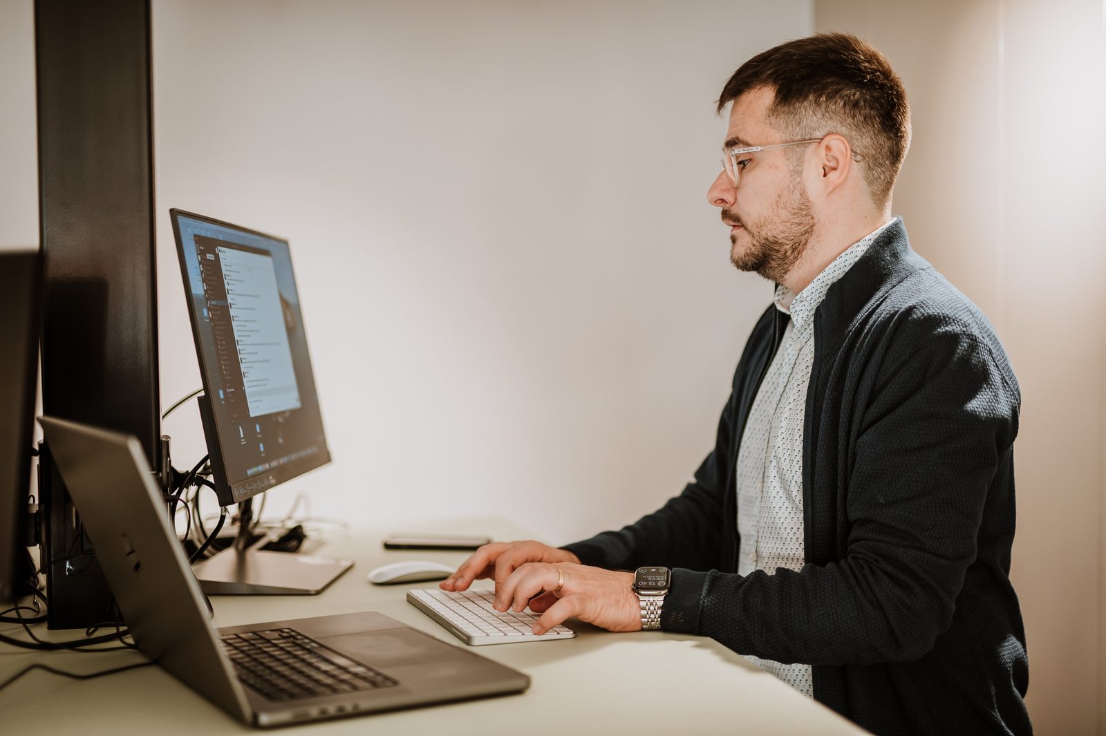 A BetterQA engineer typing at his desk in the Cluj-Napoca office