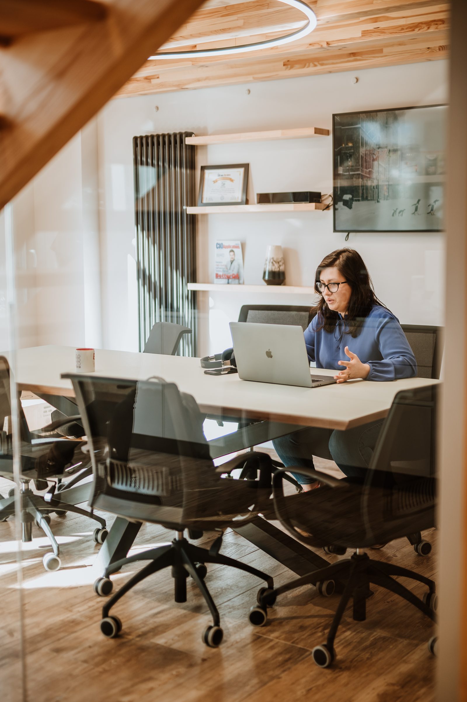 A BetterQA colleague working alone at the meeting room table