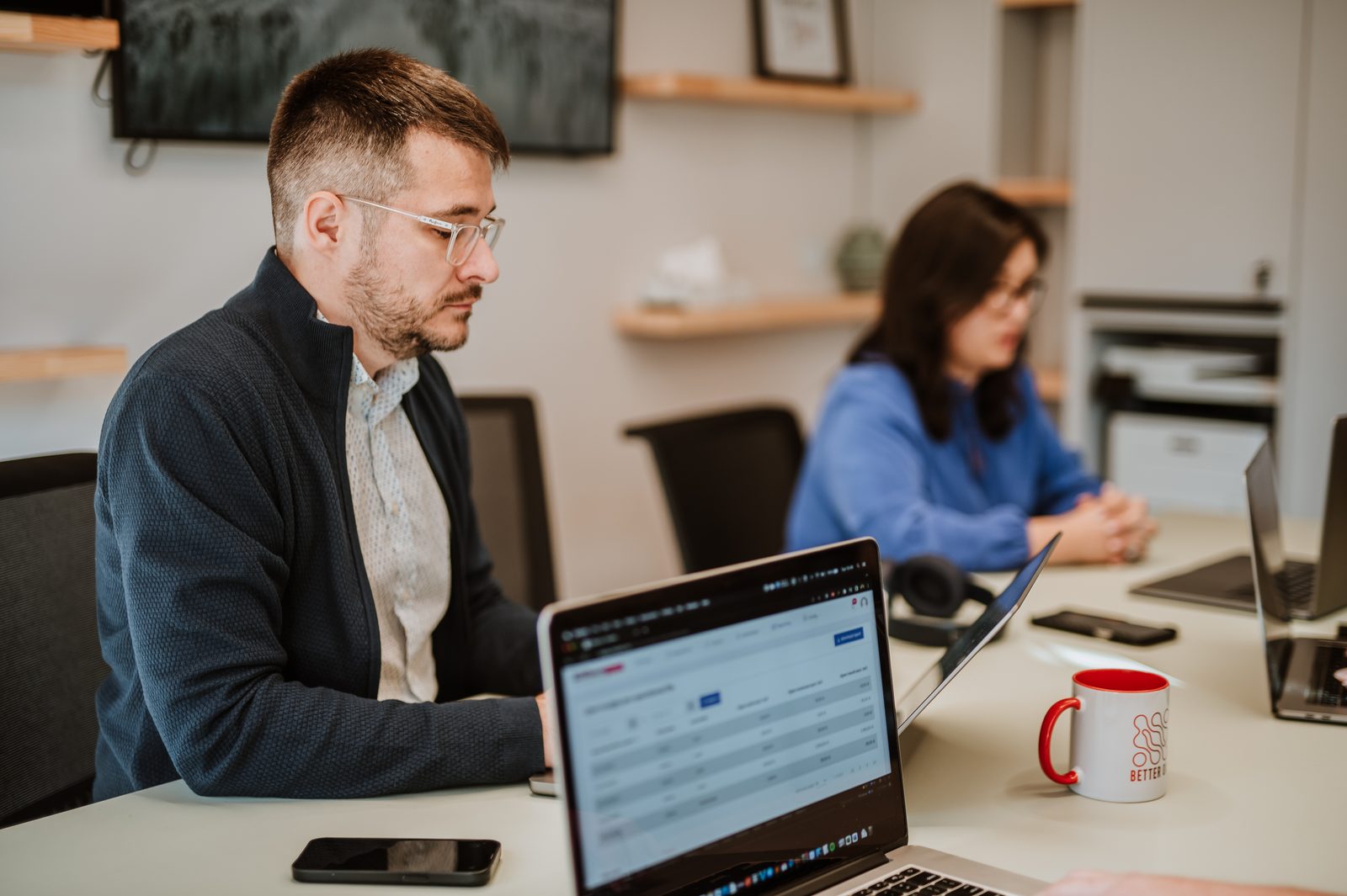 Two BetterQA colleagues working side by side in the Cluj-Napoca office